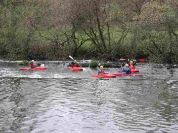 Waving kayakers below Clashganna Weir